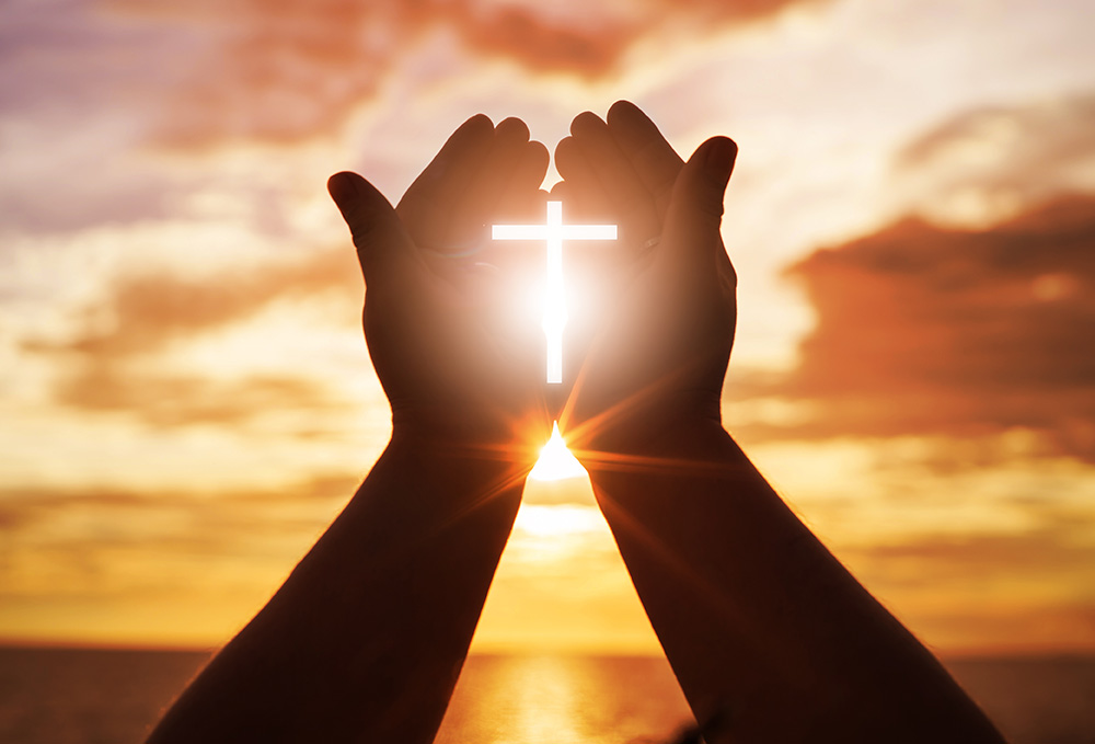 Hands showing a cross